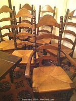 Group photo showing all six wooden ladder back dining chairs with rush woven seats and cushions. Two armchairs with arms are visible.