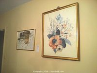 Both framed prints hung side by side on wall