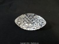 Clear Waterford crystal football figurine on black background.