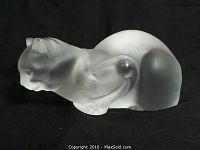 Side view of frosted crystal cat on black background