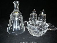 Waterford crystal bell, small bowl, salt and pepper shakers on a rectangular cut glass tray