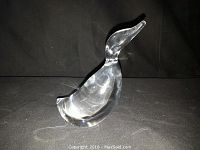 Large clear crystal duck figurine, side view, showing smooth polished crystal and curved neck