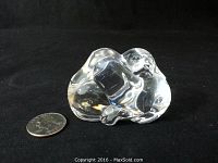 Front side view of the clear crystal figurine showing two dogs curled together.
