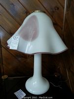Full view of the table lamp showing the mushroom-style flared glass shade and white glass base