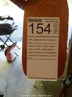 Photo of the wooden top with branding 'Chimes of Olympus' and MaxSold lot sticker, showing good condition with no defects noted.