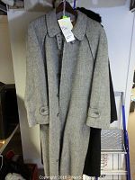 Full view of the light gray alpaca and wool Herno coat showing button front and collar.