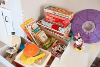 Vintage Fisher Price record player alongside children’s games and books