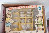 Children's china tea set in original box with cups, saucers, teapot decorated with vintage child illustrations