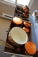 Photo showing copper pots, ceramic pot with floral design, and four metal canisters with lids missing knobs