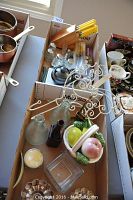 Two trays containing assorted vintage items: Antoine cosmetic jar, glass bottles, knife block with knives, salt and pepper sets, glassware and decorative container.