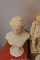 Marble bust statue showing classical female head and shoulders with some crazing on surface