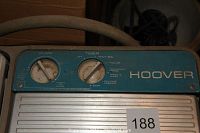 Close-up of the control panel with two rotary dials labeled 'Pump' and 'Timer' on blue background with white text and brand name Hoover.