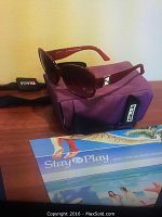 Front angle view of red gradient lensed Fendi sunglasses resting on a purple Zilla carrying case.