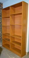 Front view of the wooden bookshelf showing two vertical sections with multiple shelves and the overall size and condition.