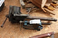 Both vises positioned side by side on workbench showing size and condition.