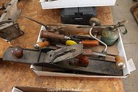 Multiple tools in box including plane, drills, oil cans, brace, spokeshave, saw, screwdriver