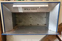 Front view of Spray Away hobby size paint booth showing metal frame, filter panel, and front label.