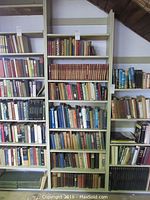 Multiple shelves of older hardback books including a red gilt Chronicles of Canada 31-volume set and miscellaneous titles