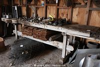 Front view of entire workbench showing top surface, integrated clamps and under-bench storage board