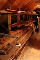 Overall view of loft shelving with stacks of rough-sawn lumber