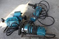 All three tools arranged together: angle grinder, trimmer and router with their cords visible.