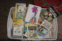 Full bin of assorted children's books including classic and adventure titles.