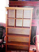 Front view of wooden shelf showing 6 cubby compartments and 3 lower shelves, natural wood finish.