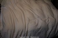 White queen size feather down comforter laid flat, showing overall size and cover fabric.