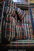 Top-down view of plaid love seat showing pattern and cushions