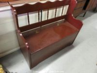 Photo of the entire wooden storage bench showing the backrest, seat, and side armrests.