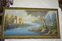 Full view of signed oil on canvas landscape painting showing tree, ruins, water, and sailboats with ornate frame.