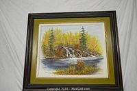 Full view of framed painting showing river, rocks, and autumn trees