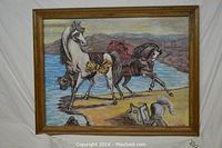Full view of the framed oil painting showing three horses near water with hills, with visible scratches on the wooden frame.