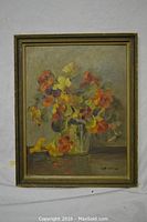 Full view of the framed oil painting showing floral arrangement and signature.