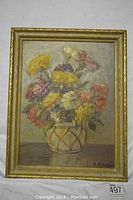 Frontal view of the floral oil painting in a gold frame showing the entire artwork and frame.