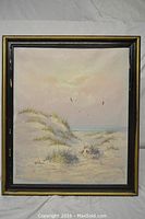 Full view of the framed acrylic painting depicting beach dunes and birds under soft colored sky, signed Gibson.