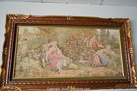 Full view of the framed tapestry showing the entire scene and frame.