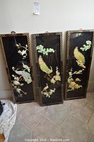 3 Asian decorative panels arranged side by side on floor showing details and condition.