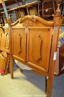 Wood twin bed headboard with floral carving and decorative raised panels, shows condition and design details.