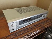 Technics SA-210 stereo receiver showing front control panel and power switch.