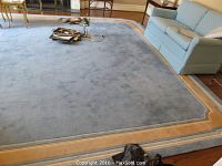 Full view of rectangular rug under sofa and chairs
