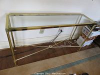 Full view of the console table showing metal frame and glass top