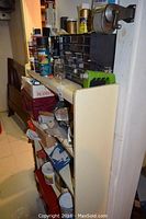 Shelf and storage organizer with assorted spray cans, small hardware drawers, tools