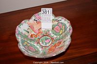 Top view showing scalloped rim, interior figural scenes and floral medallions