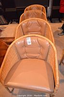 Front view of a wicker arm chair showing cushion and frame