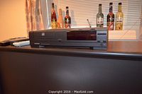 CD changer/stereo on TV stand; no speakers visible