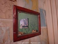 Frontal view of rectangular bamboo style wooden framed mirror hanging on wall.