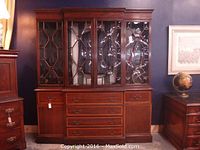 Full view of the monumental hutch buffet showing the dark wood finish, four beveled glass doors on top, six center drawers, and two cabinet doors on bottom.
