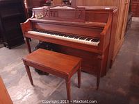 Full view of Hardman Imperial PRAKtiss upright piano with matching bench, showing wood finish and design.