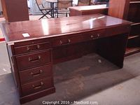 Front and side view of the Kimball executive desk showing overall structure, wood finish, and drawer arrangement.